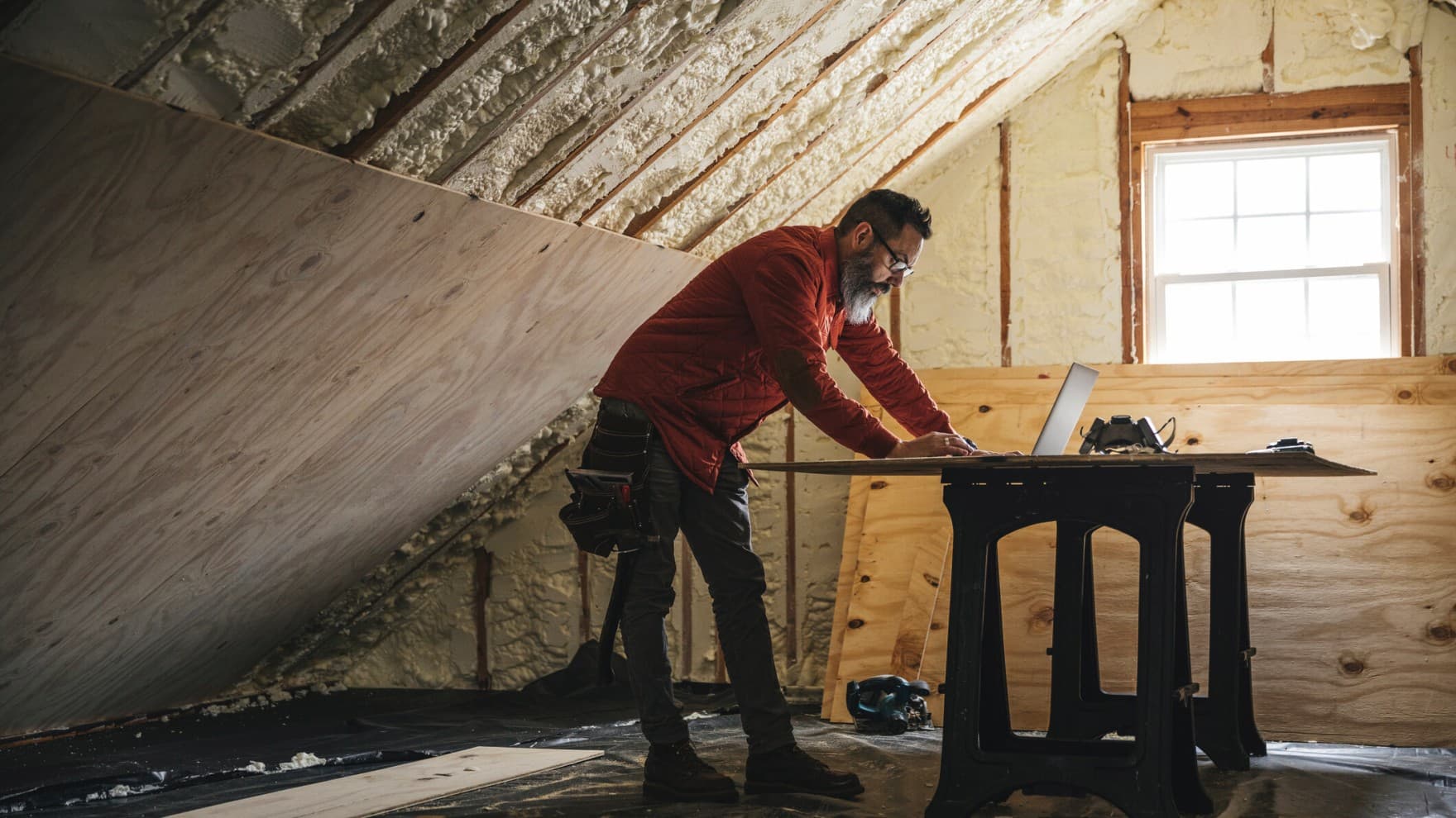 Дрводелец гледа во лаптоп за време на изолација на домот