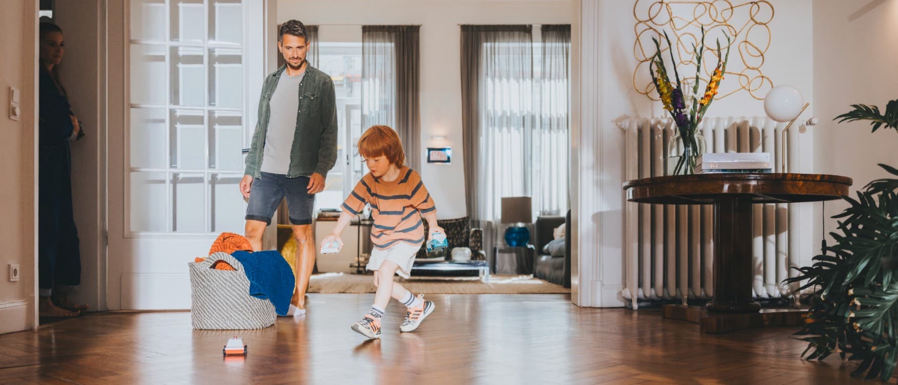 Татко го гледа својот син како си игра во дневната соба